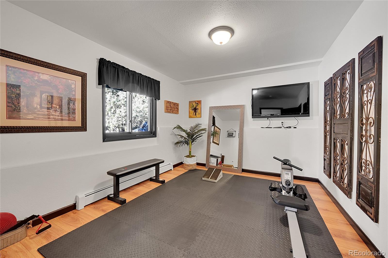 8959 South Hillview Road Morrison, CO 80465 - Photo 28 of 49 a view of a livingroom with furniture and a flat screen tv