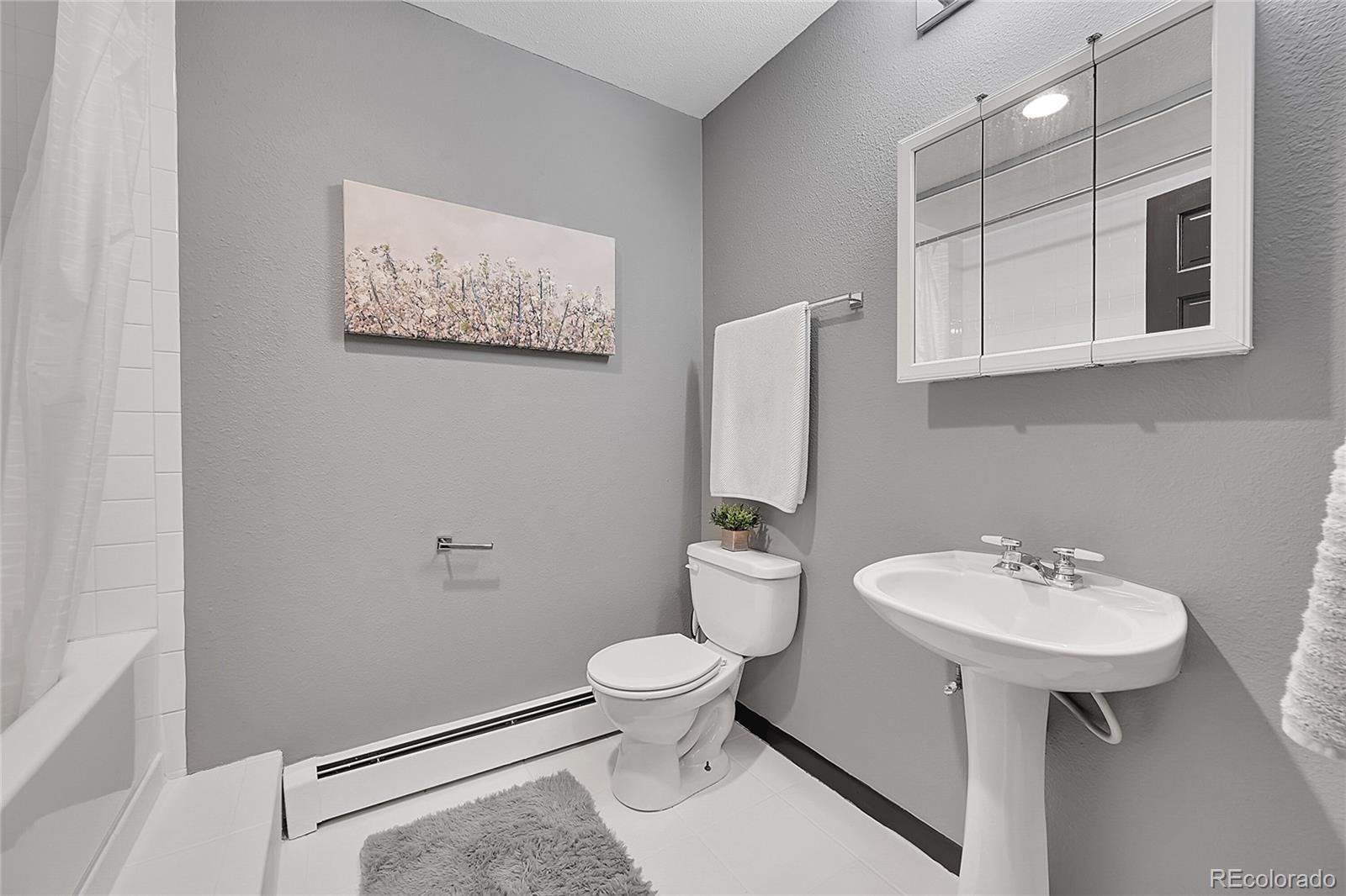8959 South Hillview Road Morrison, CO 80465 - Photo 29 of 49 a bathroom with a sink toilet and a mirror
