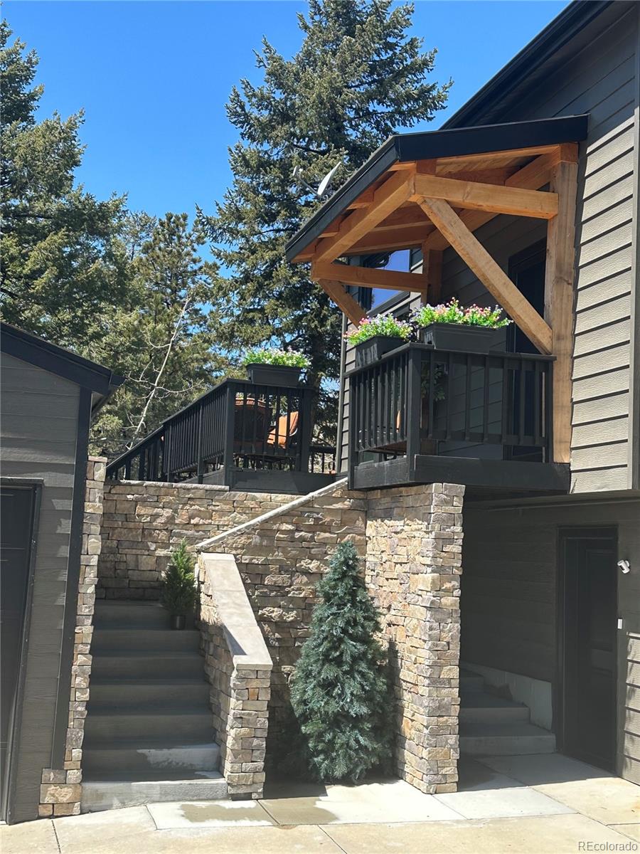 8959 South Hillview Road Morrison, CO 80465 - Photo 46 of 49 a view of house with a tree in front