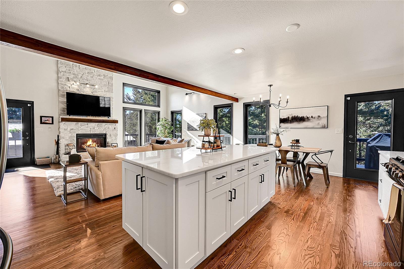 8959 South Hillview Road Morrison, CO 80465 - Photo 10 of 49 a large kitchen with stainless steel appliances a lot of counter space and a wooden floor