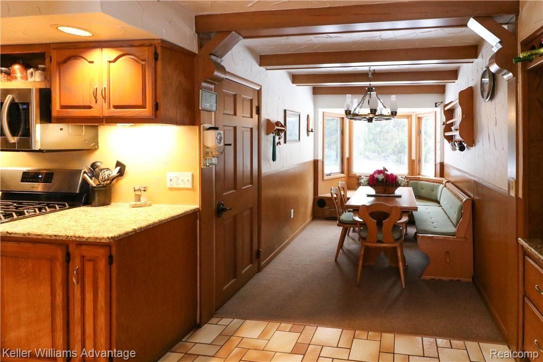 4679 Hegel Road Goodrich, MI 48438 - Photo 14 of 41 Cozy breakfast nook is a bright, cheery place to enjoy a meal! Convenient doorway access to basement as well.