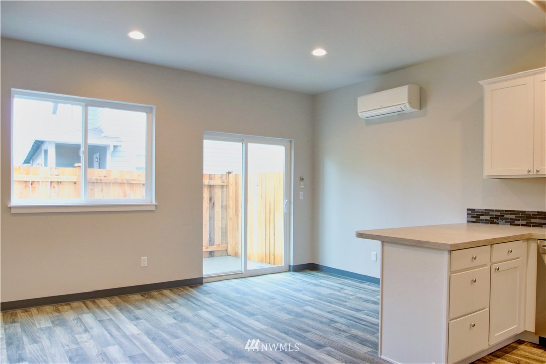 705 Peterson Road Burlington, WA 98233 - Photo 11 of 30 an empty room with wooden floor and windows