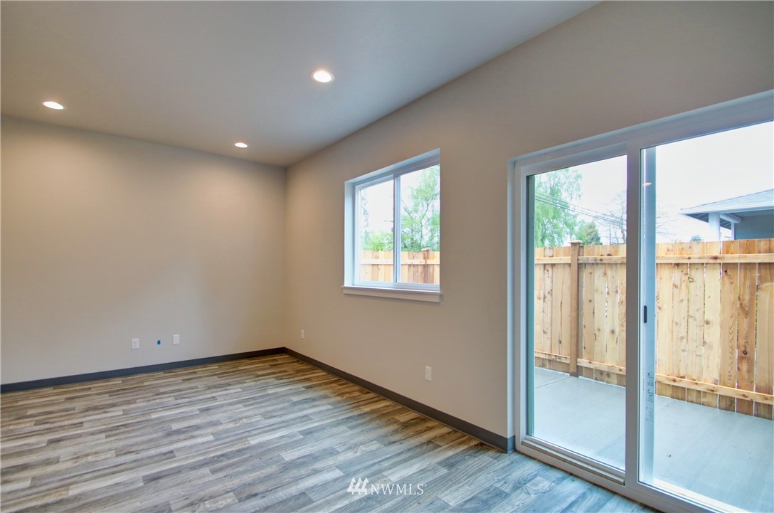 705 Peterson Road Burlington, WA 98233 - Photo 12 of 30 an empty room with wooden floor and windows
