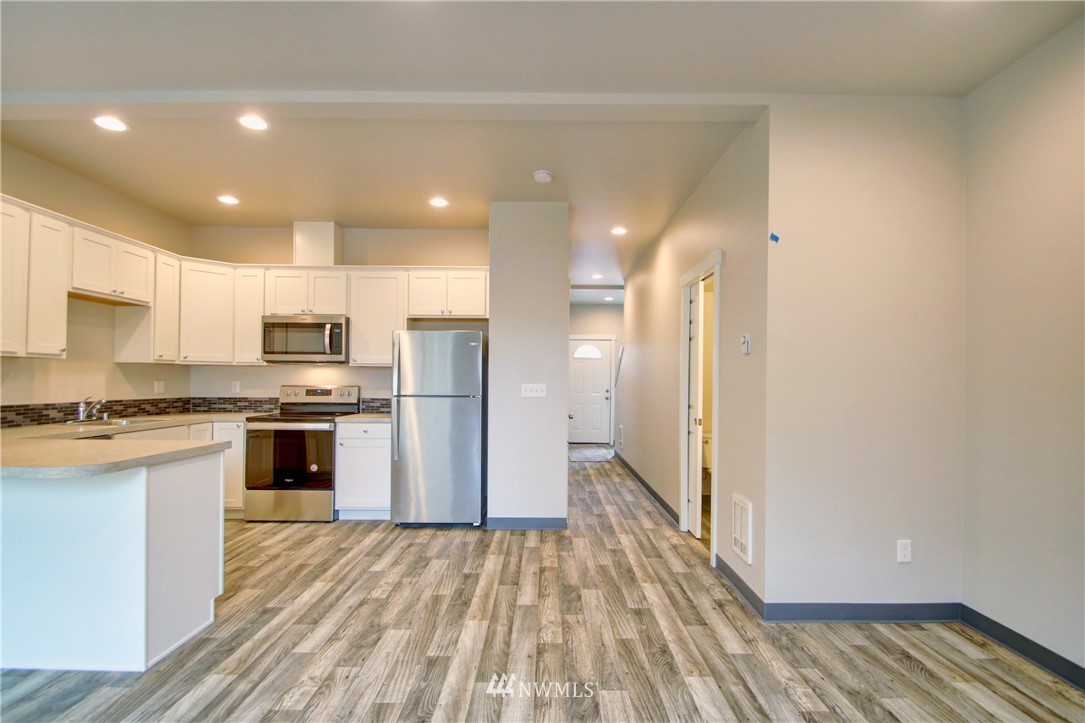 705 Peterson Road Burlington, WA 98233 - Photo 16 of 30 a kitchen with stainless steel appliances a refrigerator and a stove top oven