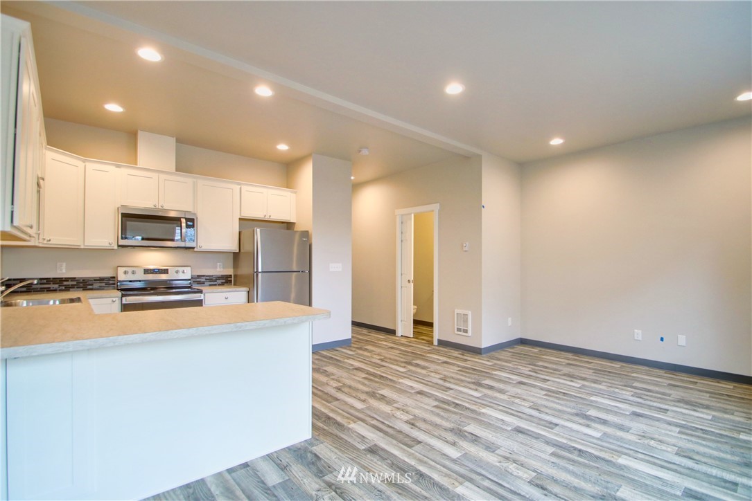 705 Peterson Road Burlington, WA 98233 - Photo 17 of 30 a large kitchen with stainless steel appliances a refrigerator and a stove top oven