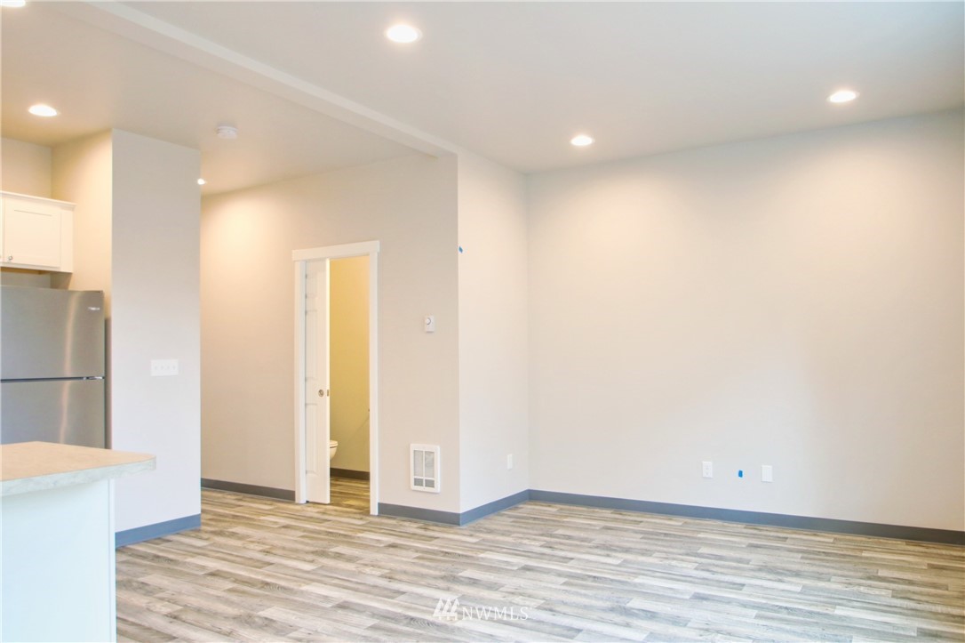 705 Peterson Road Burlington, WA 98233 - Photo 7 of 30 an empty room with wooden floor and windows