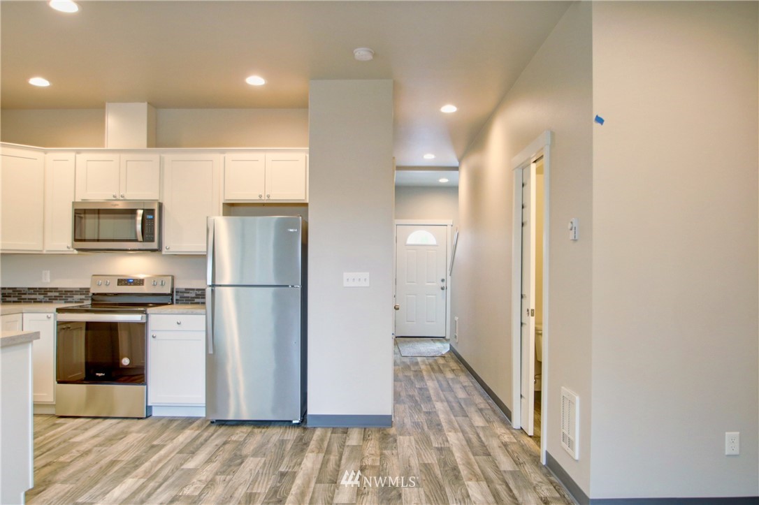 705 Peterson Road Burlington, WA 98233 - Photo 8 of 30 a kitchen with stainless steel appliances a refrigerator and a stove top oven