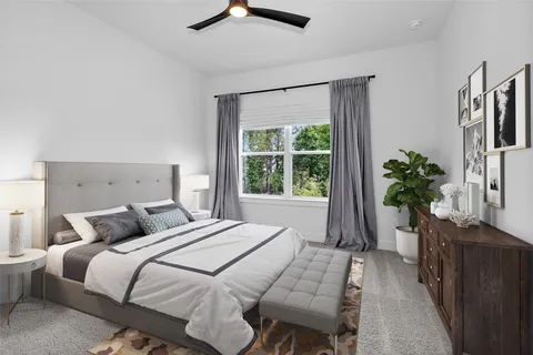 a bedroom with a bed and a potted plant