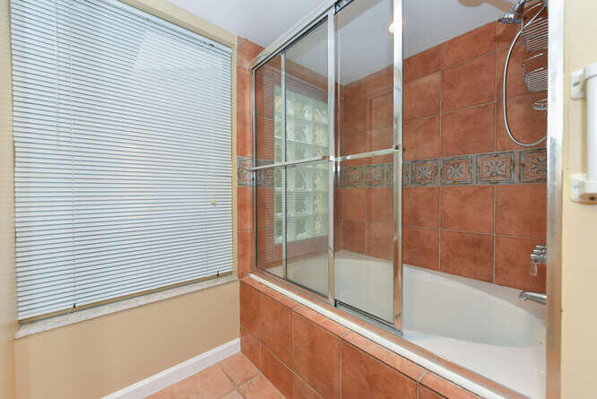 1605 Highway 1, Unit SL8B Jupiter, FL 33477 - Photo 15 of 34 a bathroom with a bathtub and shower