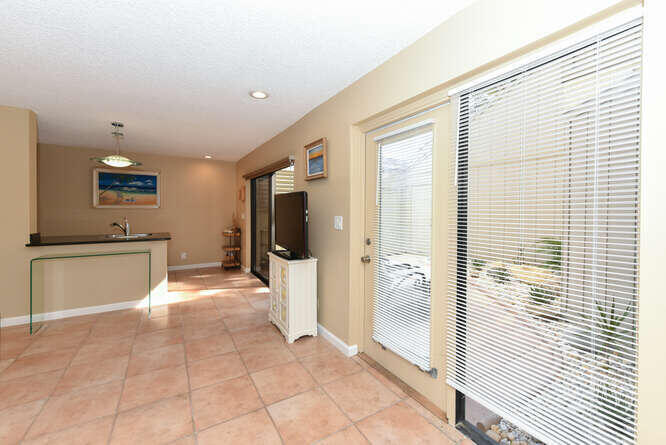 1605 Highway 1, Unit SL8B Jupiter, FL 33477 - Photo 6 of 34 a view of a kitchen with a sink and dishwasher a refrigerator with wooden floor