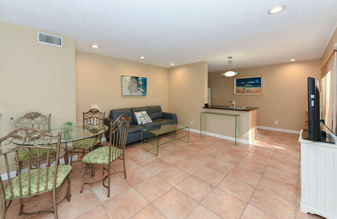 1605 Highway 1, Unit SL8B Jupiter, FL 33477 - Photo 7 of 34 a living room with furniture a flat screen tv and a table