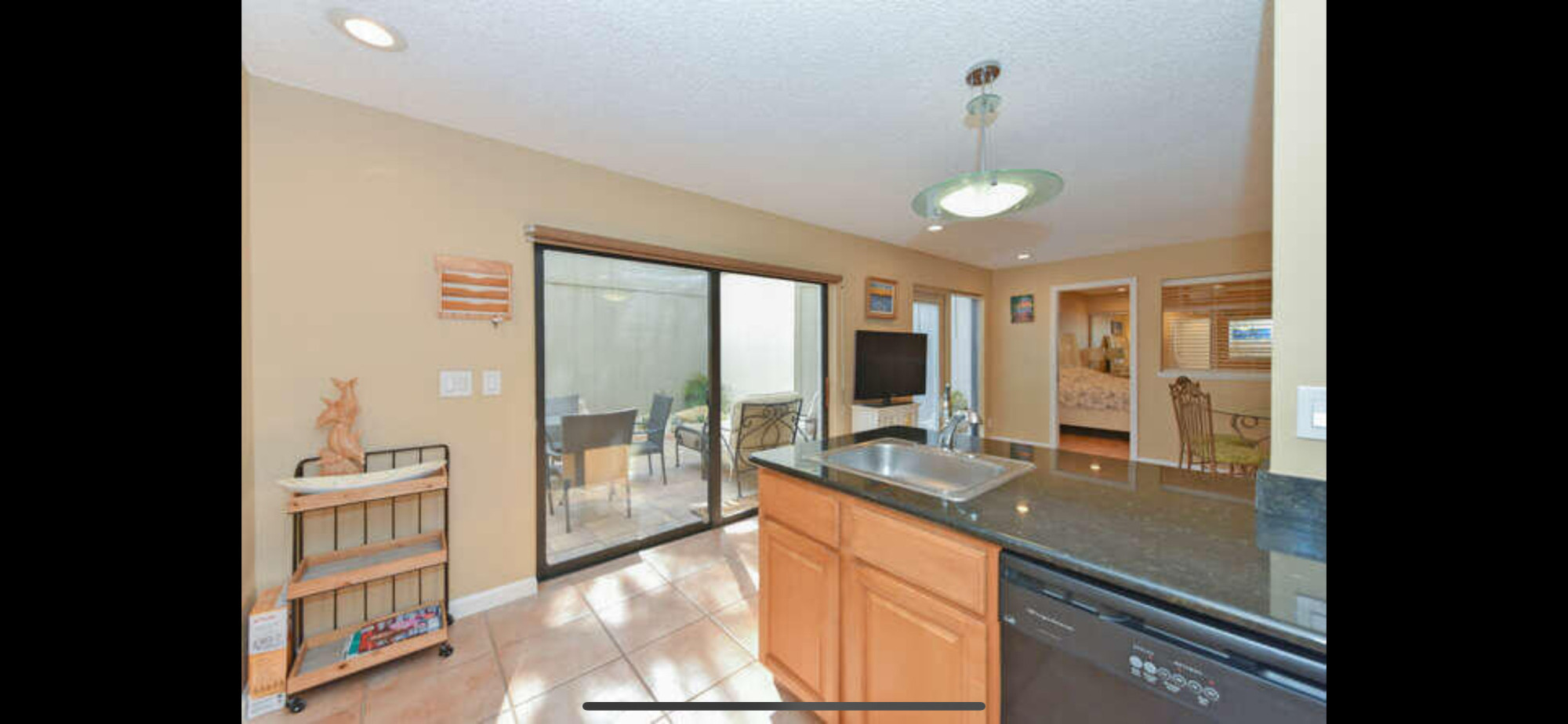 1605 Highway 1, Unit SL8B Jupiter, FL 33477 - Photo 9 of 34 a large kitchen with granite countertop a large window and a sink