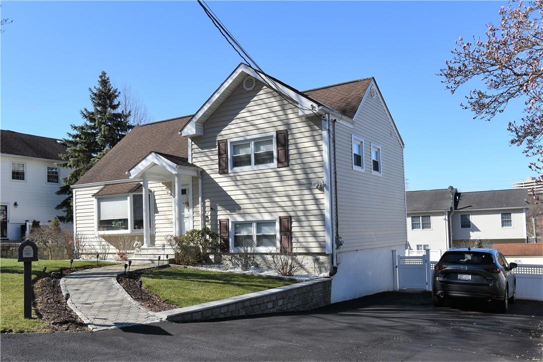 a front view of a house with a garden