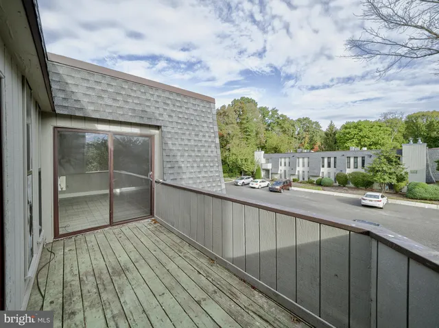 a view of a balcony with wooden floor and fence