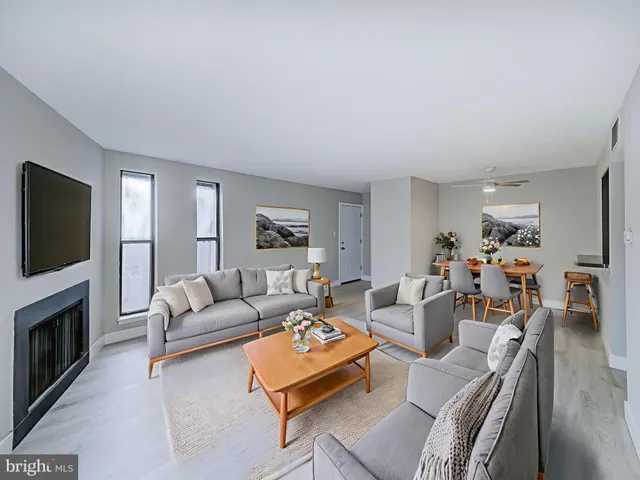 a living room with furniture flat screen tv and a fireplace