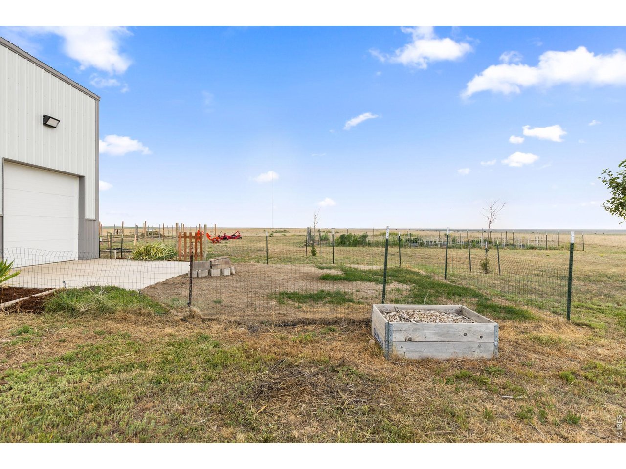 13550 Deter-Winters Road Byers, CO 80103 - Photo 27 of 50 This fenced area with a concrete pad and grass area west of the garage works great for young kids and/or pets