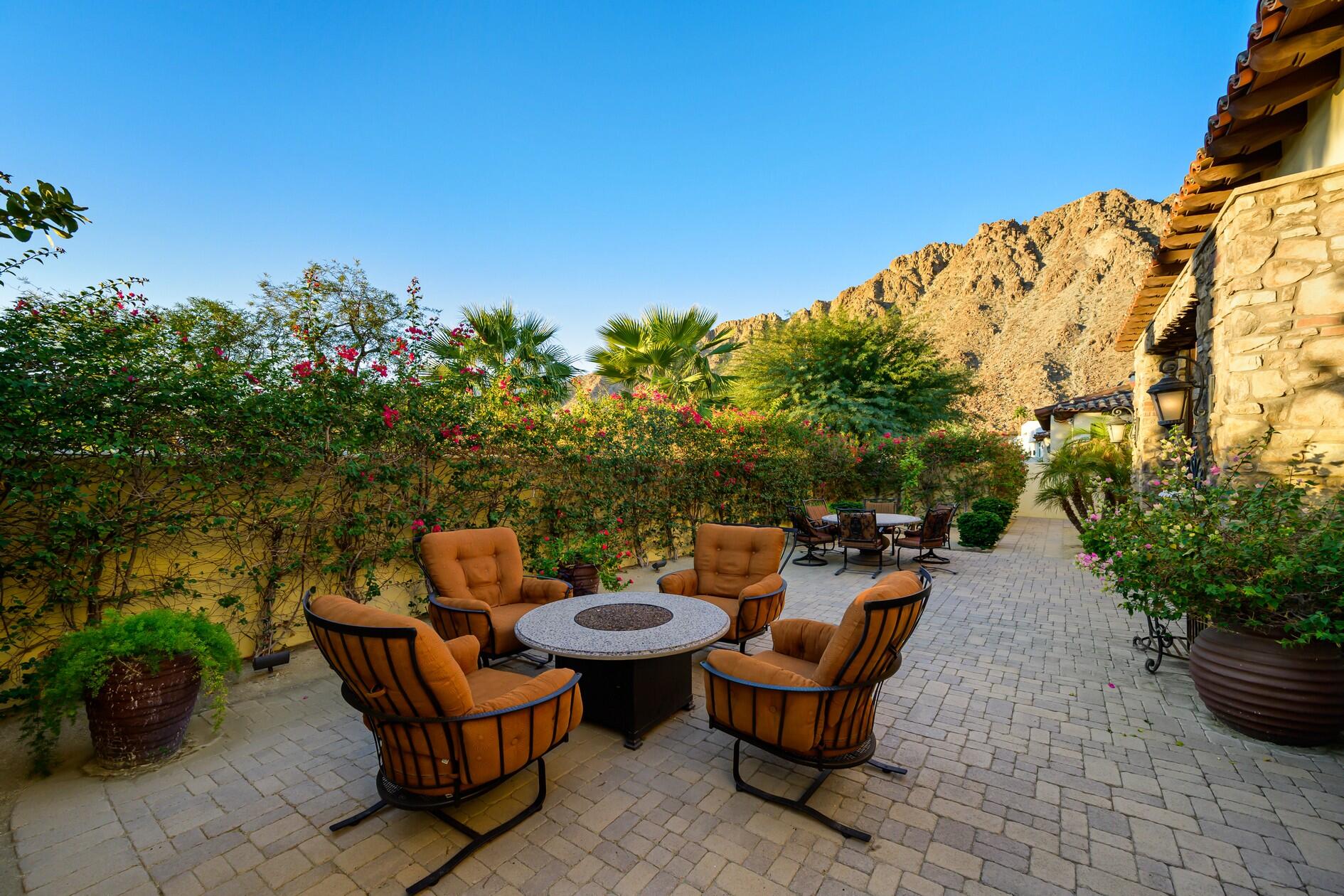 77169 Casa Del Sol La Quinta, CA 92253 - Photo 14 of 50 a backyard of a house with yard and outdoor seating