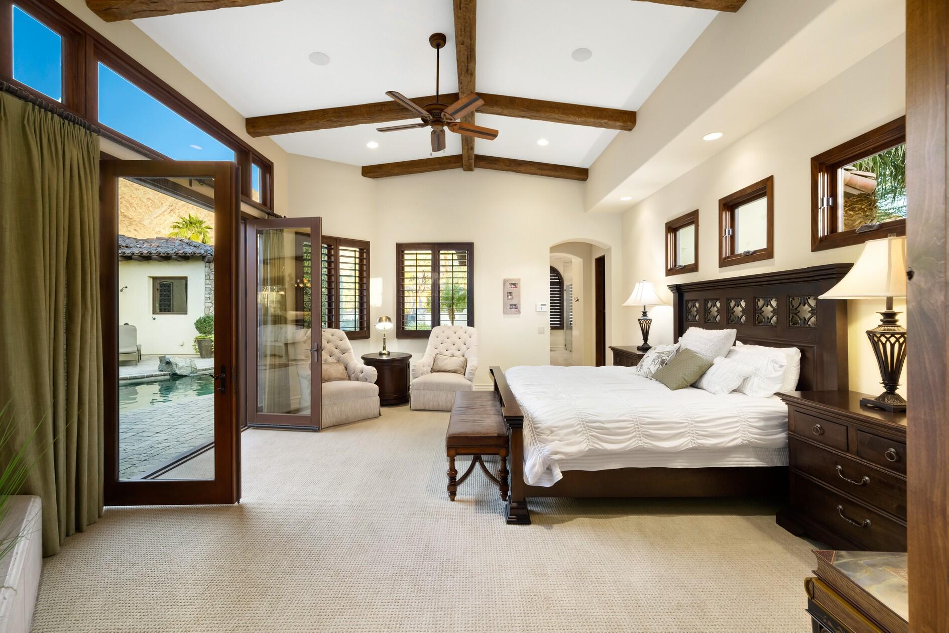 77169 Casa Del Sol La Quinta, CA 92253 - Photo 17 of 50 a bedroom with a bed couch and a ceiling fan