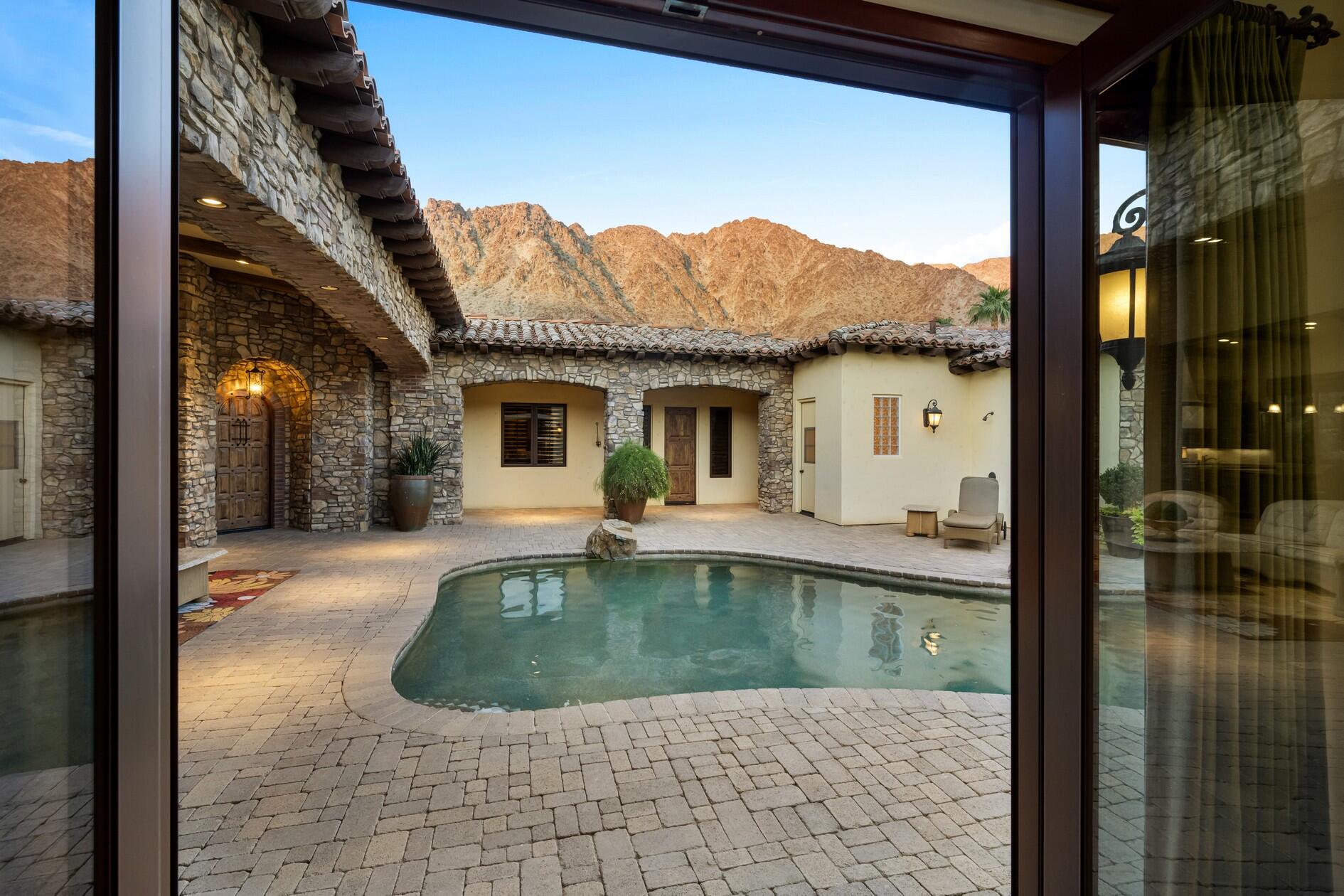 77169 Casa Del Sol La Quinta, CA 92253 - Photo 19 of 50 a view of a house with backyard porch and furniture