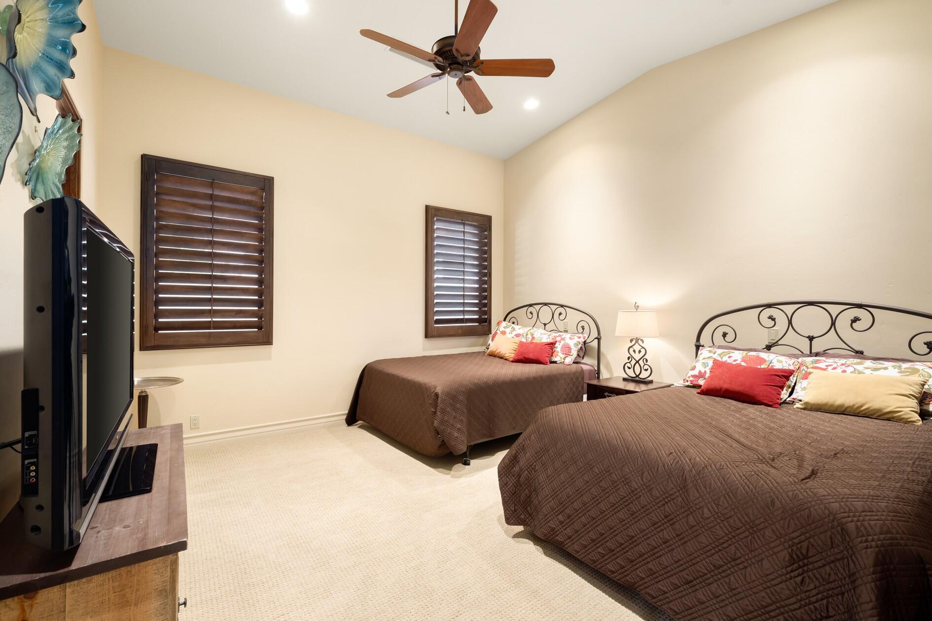 77169 Casa Del Sol La Quinta, CA 92253 - Photo 24 of 50 a bedroom with two beds and a flat screen tv