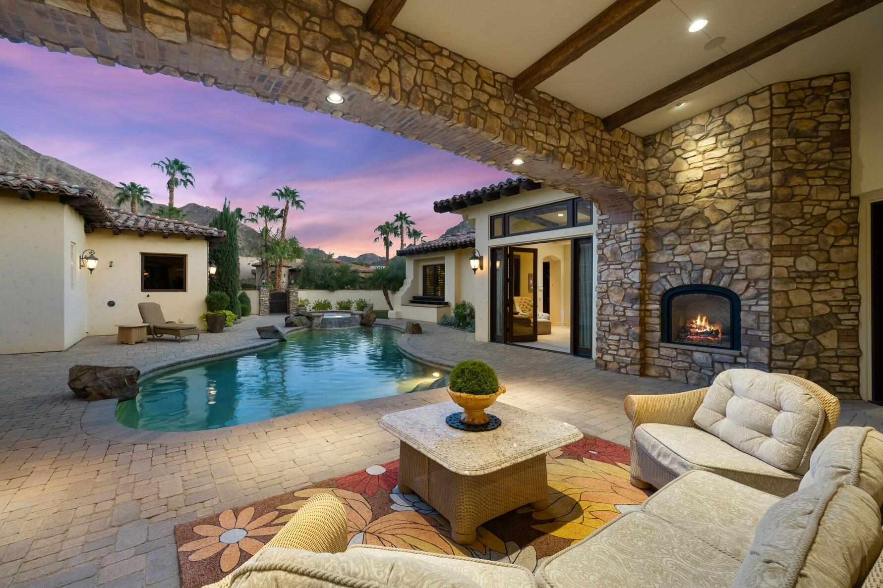 77169 Casa Del Sol La Quinta, CA 92253 - Photo 4 of 50 a living room with furniture and a fireplace