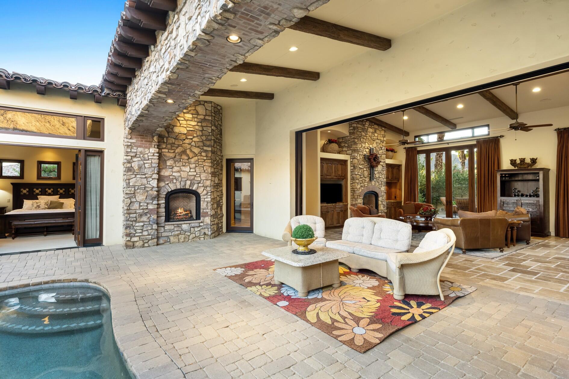 77169 Casa Del Sol La Quinta, CA 92253 - Photo 5 of 50 a living room with furniture and a fireplace