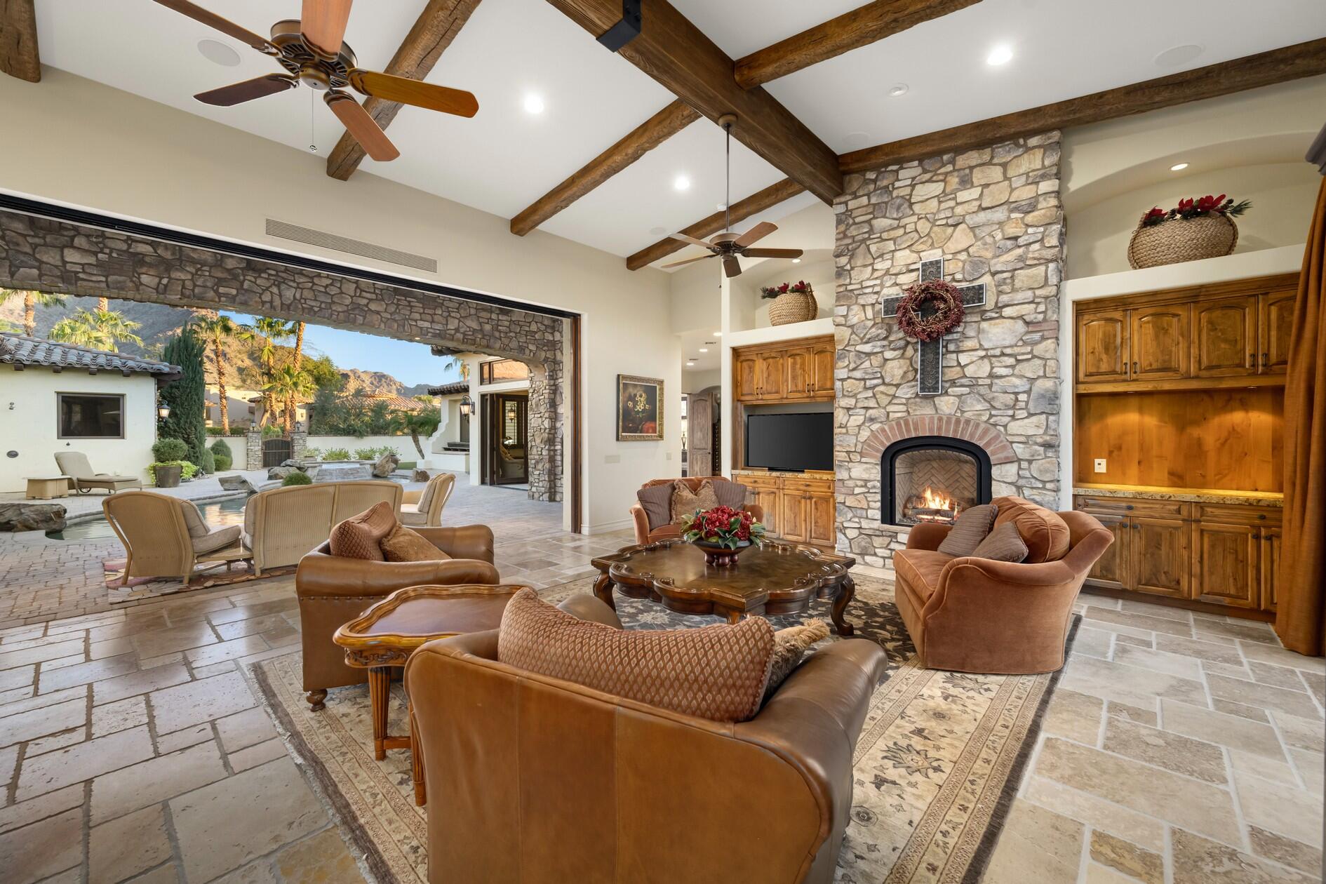 77169 Casa Del Sol La Quinta, CA 92253 - Photo 6 of 50 a living room with furniture a fireplace and a flat screen tv
