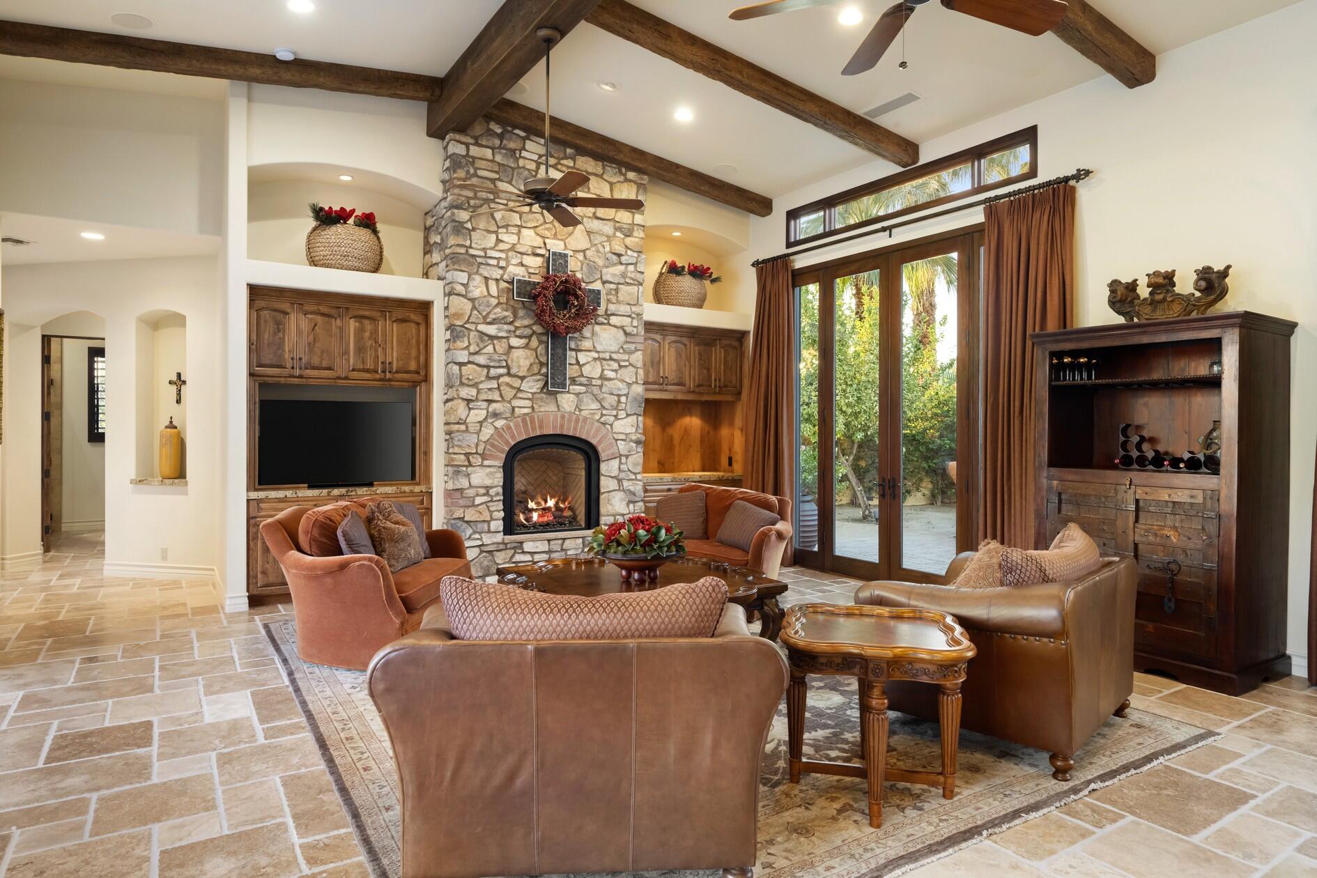 77169 Casa Del Sol La Quinta, CA 92253 - Photo 7 of 50 a living room with furniture a fireplace and a flat screen tv