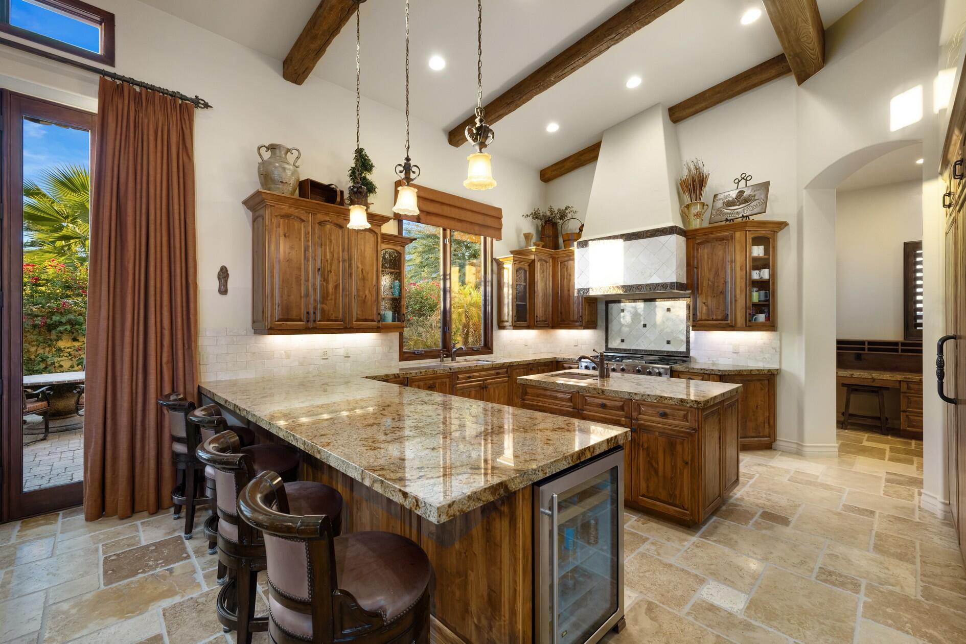 77169 Casa Del Sol La Quinta, CA 92253 - Photo 9 of 50 a kitchen with granite countertop a stove a sink and a refrigerator