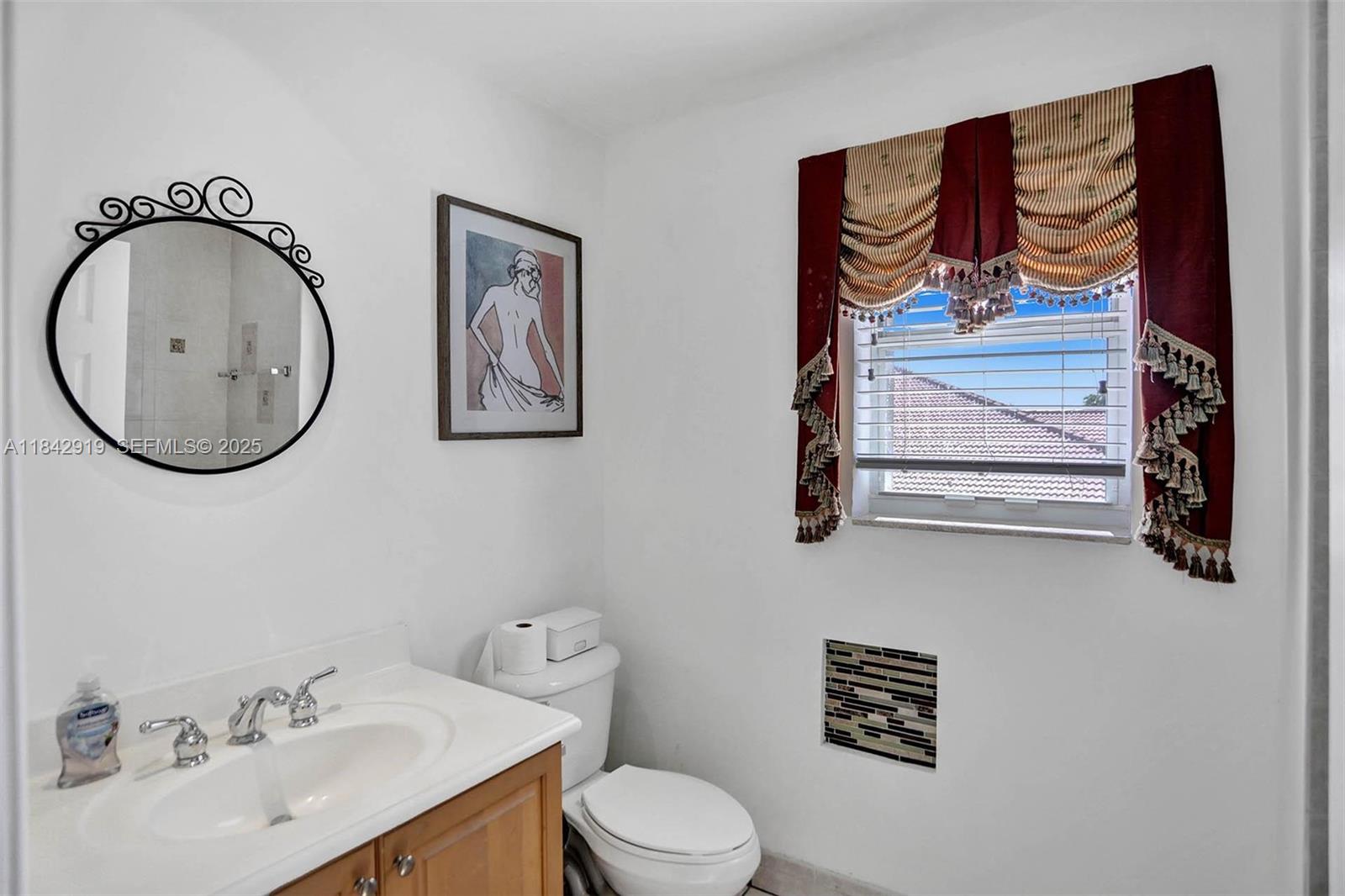 721 Ranch Road Weston, FL 33326 - Photo 28 of 38 a bathroom with a toilet a sink and a mirror
