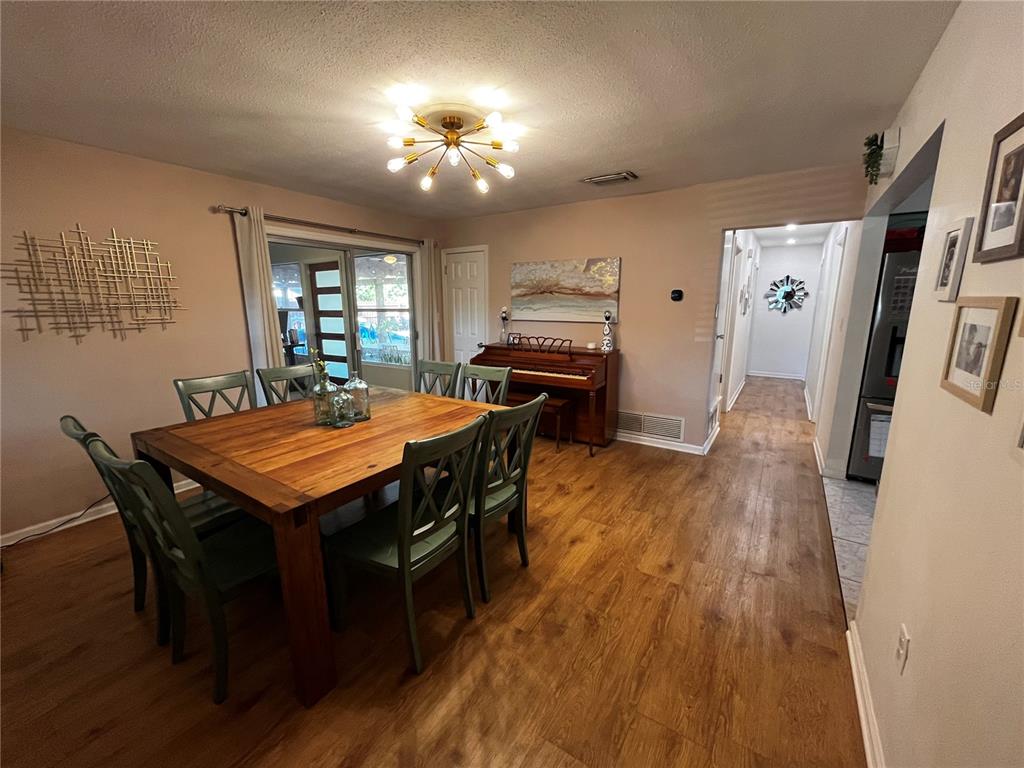 714 Denton Road Winter Park, FL 32792 - Photo 11 of 32 a dining room with a table chairs and kitchen view
