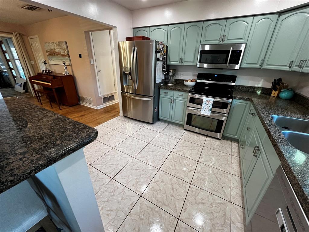 714 Denton Road Winter Park, FL 32792 - Photo 14 of 32 a kitchen with stainless steel appliances cabinets a sink and a counter top space