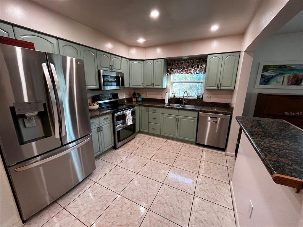 714 Denton Road Winter Park, FL 32792 - Photo 15 of 32 a kitchen with stainless steel appliances granite countertop a refrigerator stove and sink