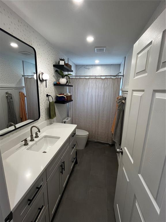 714 Denton Road Winter Park, FL 32792 - Photo 16 of 32 a bathroom with a double vanity sink and mirror