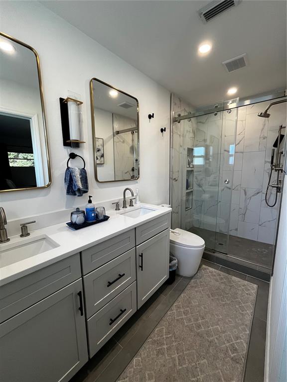 714 Denton Road Winter Park, FL 32792 - Photo 19 of 32 a bathroom with a double vanity sink toilet and shower