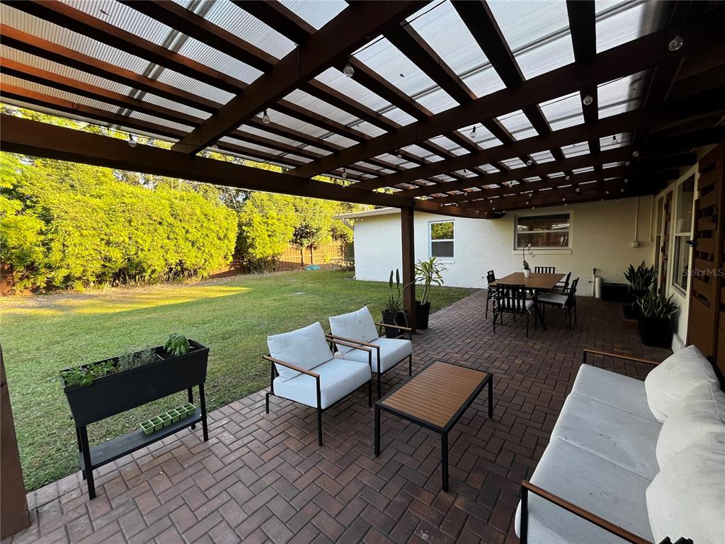 714 Denton Road Winter Park, FL 32792 - Photo 24 of 32 a living room with patio furniture and a garden