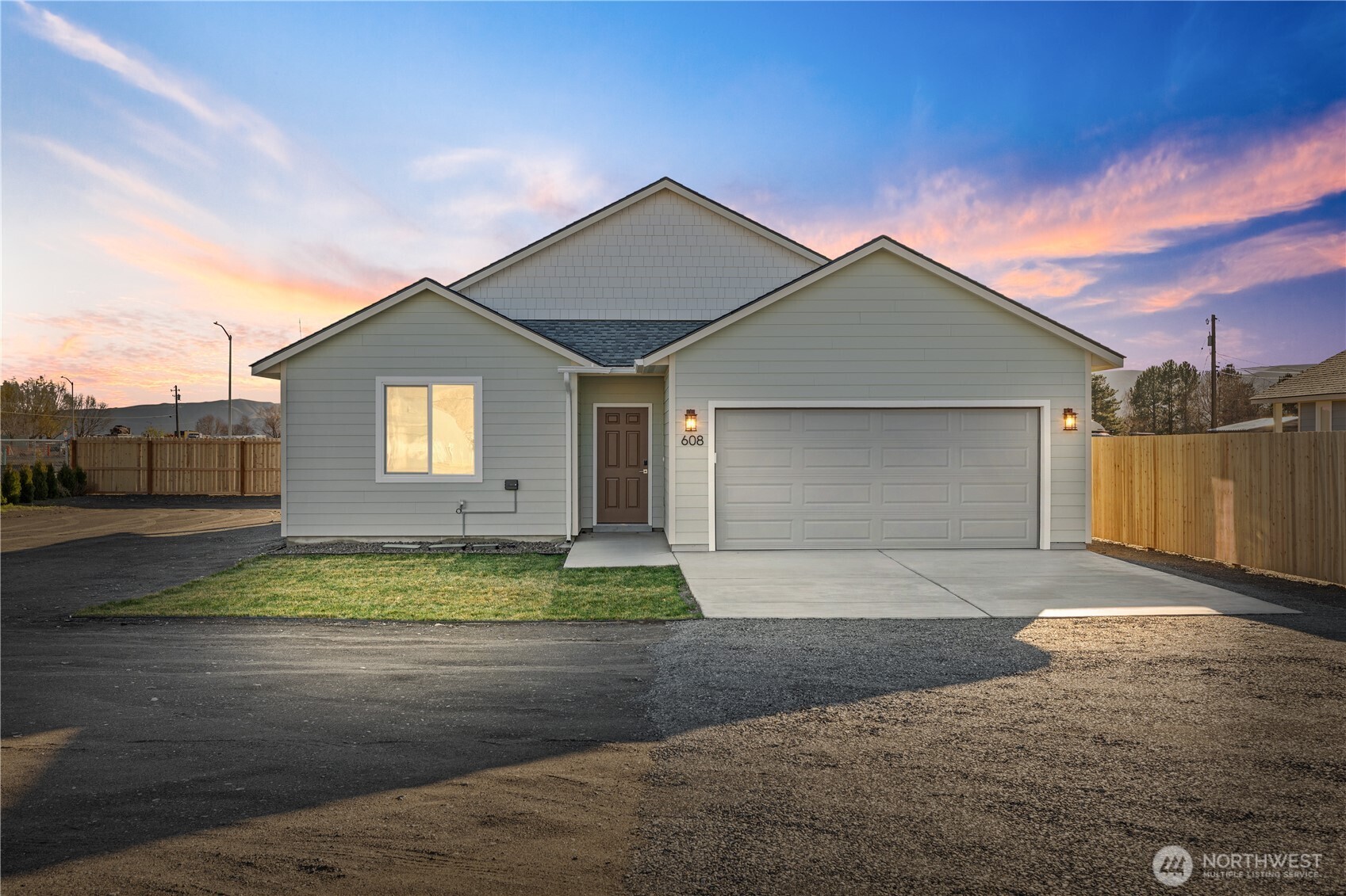 608 4th Street Mattawa, WA 99349 - Photo 1 of 40 a front view of a house with a yard and garage
