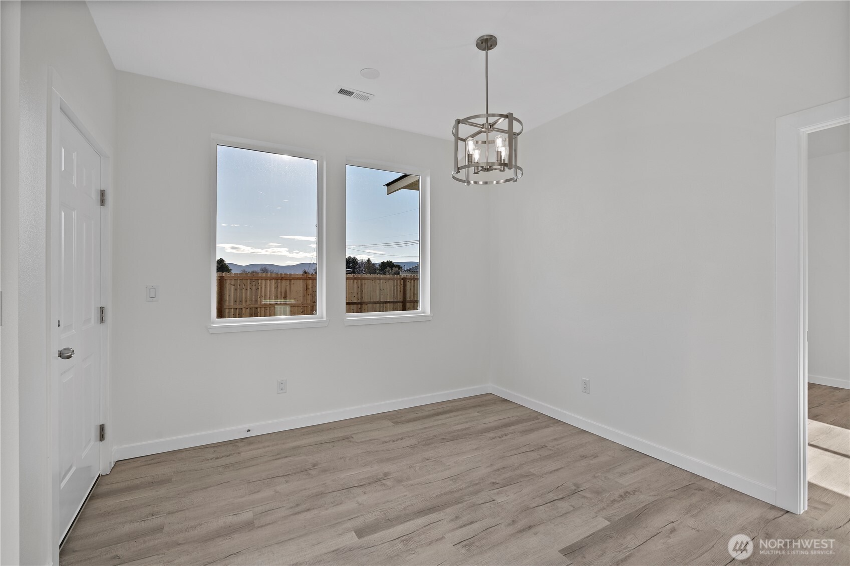 608 4th Street Mattawa, WA 99349 - Photo 19 of 40 an empty room with wooden floor and windows