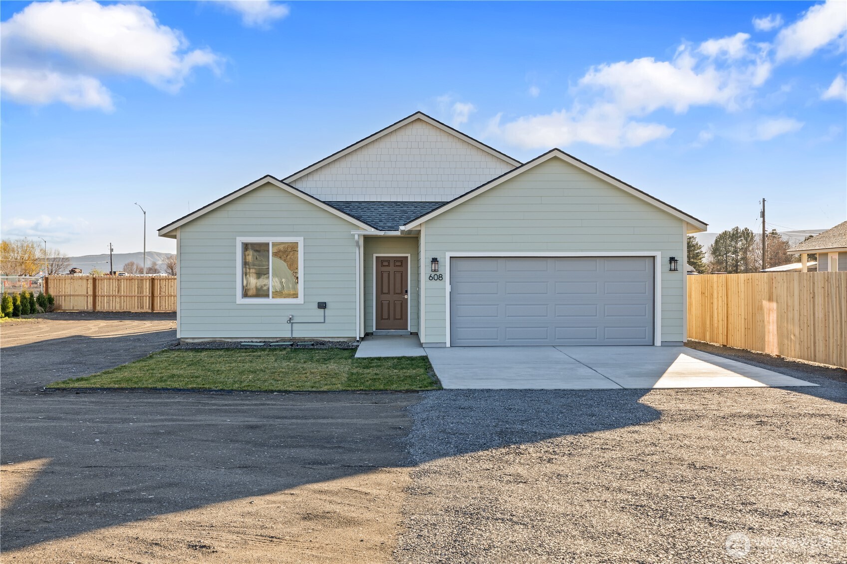 608 4th Street Mattawa, WA 99349 - Photo 31 of 40 a front view of a house with a yard and garage
