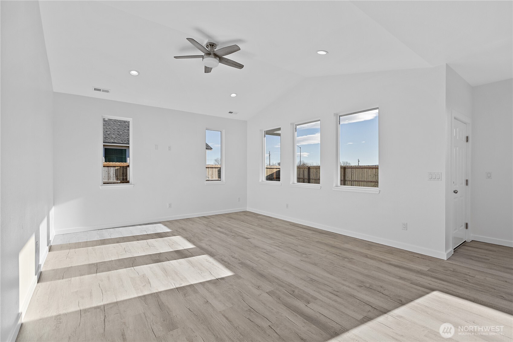 608 4th Street Mattawa, WA 99349 - Photo 4 of 40 a view of an empty room with wooden floor and a ceiling fan
