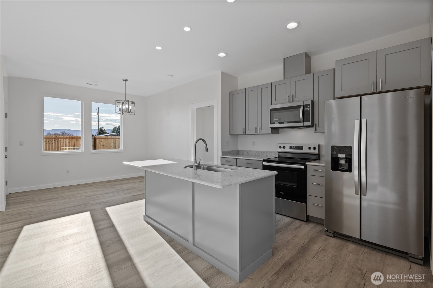 608 4th Street Mattawa, WA 99349 - Photo 8 of 40 a kitchen with kitchen island a refrigerator sink and stove