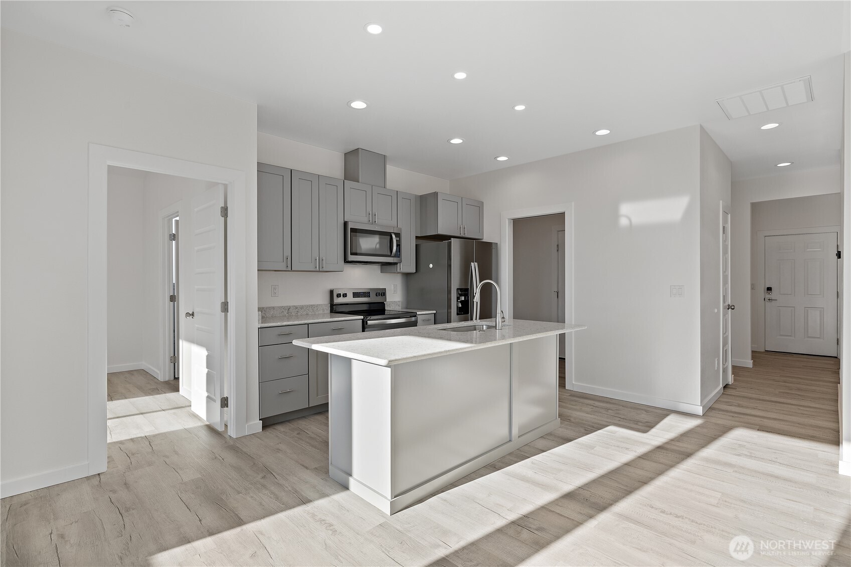 608 4th Street Mattawa, WA 99349 - Photo 9 of 40 a kitchen with white cabinets and stainless steel appliances