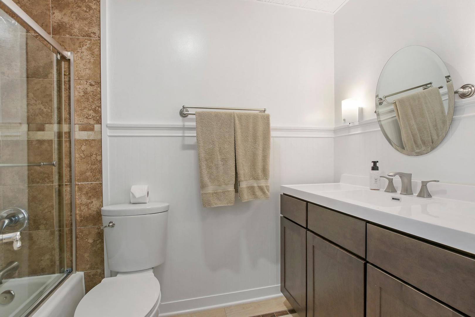 703 Crestview Drive Ingleside, IL 60041 - Photo 12 of 28 a bathroom with a granite countertop toilet sink and mirror