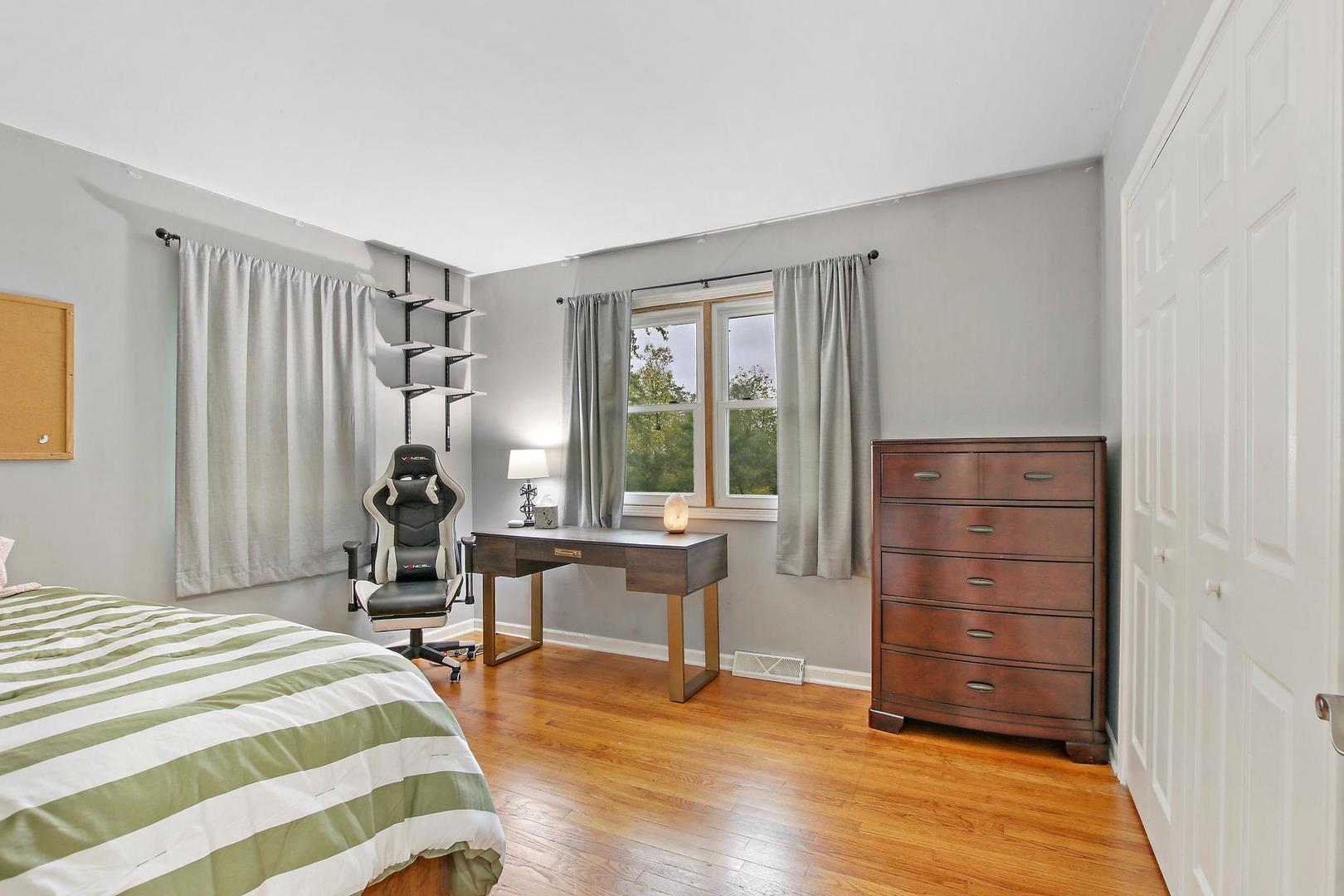 703 Crestview Drive Ingleside, IL 60041 - Photo 14 of 28 a bedroom with a bed and a window
