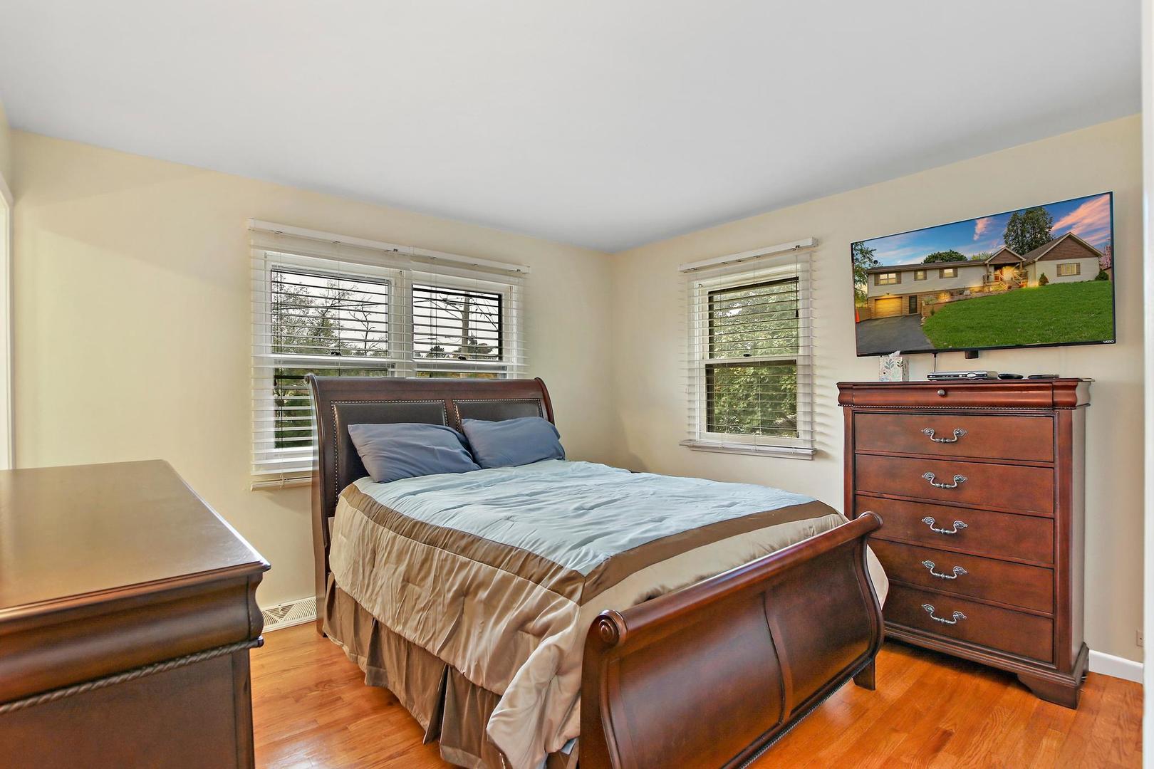 703 Crestview Drive Ingleside, IL 60041 - Photo 15 of 28 a bedroom with a bed and a flat screen tv