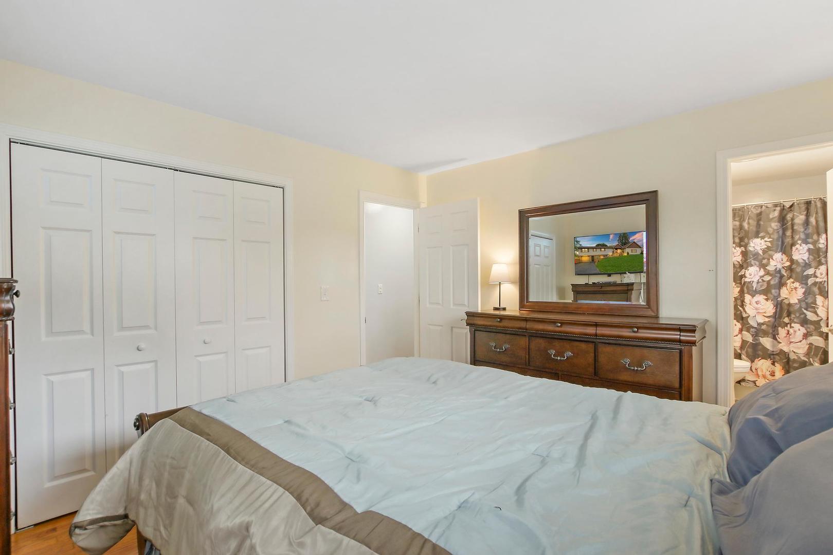 703 Crestview Drive Ingleside, IL 60041 - Photo 16 of 28 a bedroom with a bed and a dresser