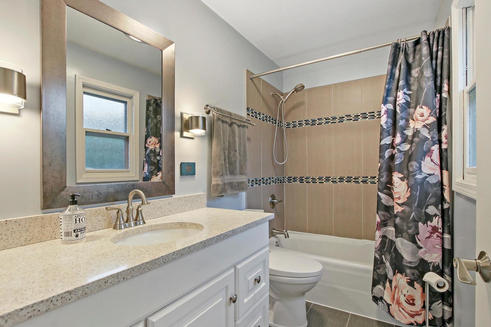 703 Crestview Drive Ingleside, IL 60041 - Photo 17 of 28 a bathroom with a granite countertop sink toilet and shower