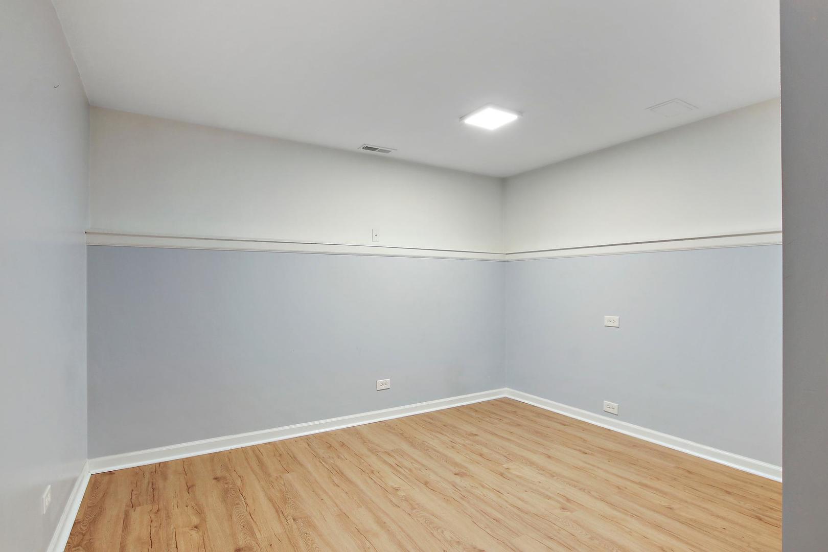 703 Crestview Drive Ingleside, IL 60041 - Photo 18 of 28 a view of a room with wooden floor