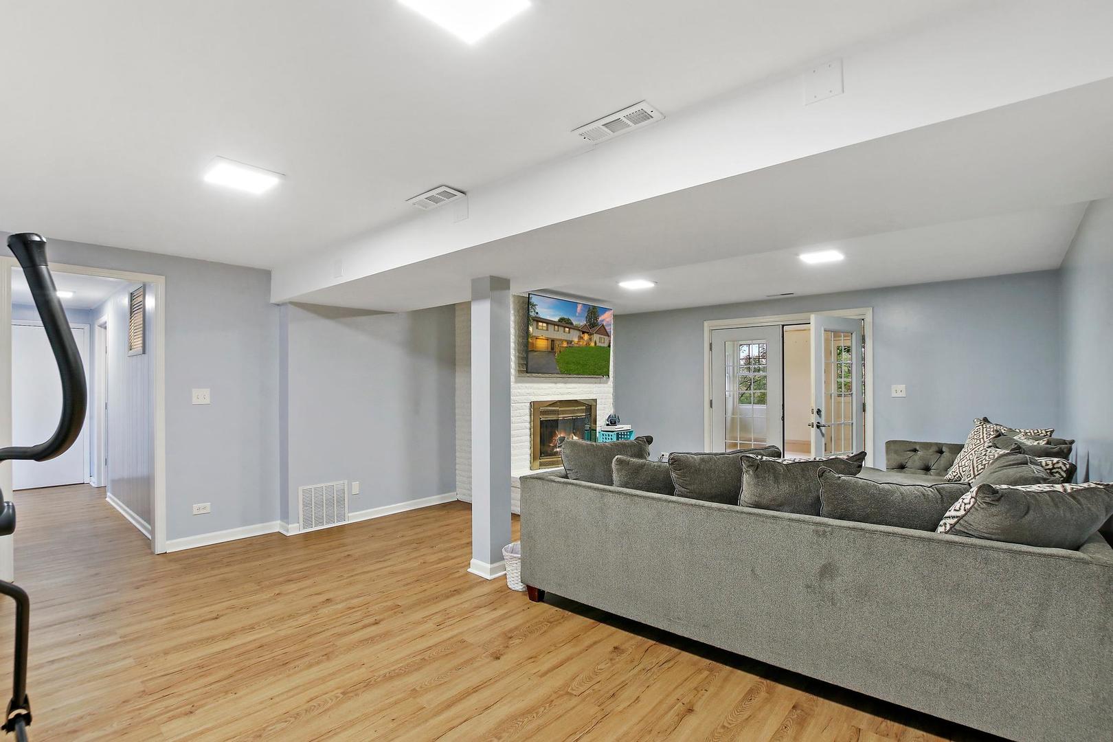 703 Crestview Drive Ingleside, IL 60041 - Photo 19 of 28 a living room with furniture and a large window