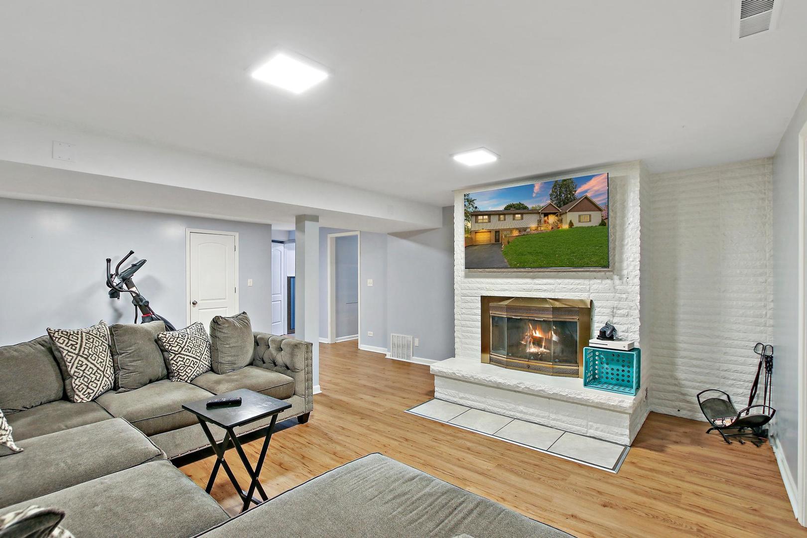 703 Crestview Drive Ingleside, IL 60041 - Photo 20 of 28 a living room with furniture and a fireplace